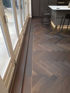 an empty room with wooden floors and glass doors on the windowsills is shown