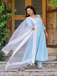 Light blue Anarkali Kurti with matching pants and tissue fabric dupatta, has a round neck and three-quarter sleeves, embellished with polka printed all over and pom lace on the hemline and sleeves Neck: Round Neck Sleeve Length: 3/4thSleeve Kurta Length: Ankle Length Fabric: Kurta & Bottom - Rayon Dupatta - Tissue Note: Wash Care Instructions - Dry Clean Only. The product will be shipped within 15-20 days of the order placed Measurements: Size Bust Waist Hip XS 34 28 36 Size 36 30 38 M 38 32 40 Blue Long Sleeve Churidar With Gota Work, Blue Cotton Anarkali Set With Gota Work, Blue Cotton Salwar Kameez With Gota Work, Blue Traditional Wear With Sheer Dupatta In Cotton, Traditional Blue Cotton Wear With Sheer Dupatta, Anarkali Cotton Set With Sheer Dupatta, Sheer Dupatta Anarkali Cotton Set, Anarkali Cotton Salwar Kameez With Sheer Dupatta, Cotton Fitted Anarkali Set With Sheer Dupatta