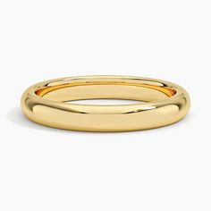 a yellow gold wedding ring with curved edges on a white background, the band is slightly flat