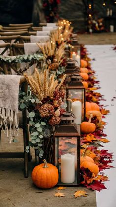 a long table with candles and pumpkins on it