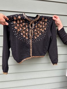 Incredibly lovely hand-embellished sequined black cardigan from I Did It by Mathew H USA, women's vintage size M, absolutely gorgeous use of sequins to make gold roses on front - runs small, please review following dimensions carefully.  Lavishly embellished with gold sequins and glass beads, no missing sequins or beading that we can see on body or bottom - a few missing sequins on wrist backs.  Fully lined in black nylon "silk" on body and arms.  Made from a  70/20/10 lambswool/rabbit-angora/ny Embellished Black Cardigan For Winter, Black Embellished Cardigan For Winter, Black Embellished Winter Cardigan, Black Embellished Cardigan For Party, Vintage Embellished Tops For Fall, Vintage Long Sleeve Cardigan For Evening, Vintage Cardigan For Evening In Winter, Vintage Evening Cardigan For Winter, Vintage Winter Cardigan For Evening