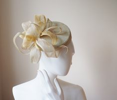 This is a light summery sinamay pillbox hat perfect for a special occasion or a day at the races. The shape of this pillbox is quite strong but it is softened by the exuberant flower trimming, giving it a very feminine look. The lighness of the sinamay makes it ec=xtrememly comfortable for wearing all day. The pillbox hat is made from scratch.  The pillbox hat is finished with hat elastic. The diameter of the hat is about 15 cm This floral sinamay pillbox hat can be made to order in the colours Summer Sinamay Fascinator For Races, Gold Short Brim Fascinator For Summer, Gold Short Brim Summer Fascinator, Sinamay Hat Fascinator For Royal Ascot, Summer Sinamay Fascinator With Structured Crown, Summer Fascinator With Structured Crown In Sinamay, Summer Mini Hat With Structured Crown In Sinamay, Sinamay Fascinator With Curved Brim For Royal Ascot, Summer Sinamay Headpiece For Races