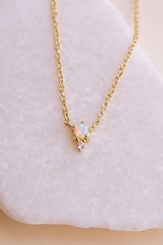 Our Odessa Opal Necklace is a piece you’ll fall in love with! Featuring a mesmerizing lab opal stone set in 14k gold-plated brass, this necklace adds a touch of elegance to any look. Whether you’re wearing it while running errands or for a glamorous night out, this versatile necklace is sure to become a new staple in your collection. Trust us - you'll be grabbing this one first from your jewelry box. NECKLACE FEATURES Material: Brass, Lab Opal Stone Dimensions/Size: 15.75" length + 2.25" extende Opal Necklace Simple, Gold Opal Necklace, Simple Gold Jewelry, Box Necklace, Gold Jewelry Simple, Bohemian Necklace, Opal Stone, Opal Necklace, Odessa