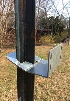 a close up of a metal pole in the grass