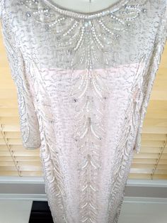 "This vintage beauty is from in excellent condition! It's beautifully embellished with iridescent sequins and accented with glass beading and pearls. Measurements: Bust - 38\" Waist - 36\" Hips - 38\" Shoulders - 15\" Sleeves - 19\" Dress Length - 55\" All of my items come from a smoke-free and pet-free home. If you would like more info or have any questions, please don't hesitate to ask!" Fitted Sequin Mother Of The Bride Dress, Elegant Sequin Fabric For Evening Dress And Festive Occasions, Elegant Pearl Embroidered Sequin Fabric For Evening, Elegant Evening Pearl Embroidered Sequin Fabric, Glamorous Sequin Dress For Wedding And Festive Occasions, Fitted Sequin Evening Dress For Mother Of The Bride, Glamorous Embellished Mother Of The Bride Dress, Mother Of The Bride Fitted Sequin Evening Dress, Festive Embellished Mother Of The Bride Dress For Party