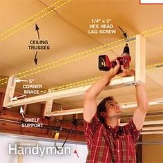 a man is working on the ceiling in his garage with tools and screwdrivers