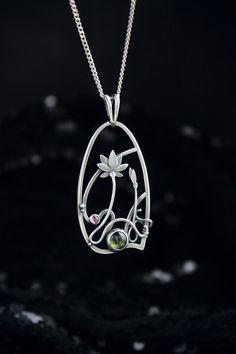 ITEM DESCRIPTION: The size H 4 cm x W 3 cm (1 3/4 x 1 inch). Weight - 6g. You can buy it with the chain or without. The most delicate flower of the lotus can make someone very happy. I made this botanical jewelry of sterling silver, peridot, and rhodolite garnet. This is a true work of art. It will emphasize your exquisite taste and status, and will also bring a lot of compliments. Ooak jewelry made by eco-friendly materials. The parcel will be sent during 1-2 days after payment. Delivery usuall Nature-inspired Nickel-free Jewelry With Round Pendant, Nickel-free Nature-inspired Jewelry With Round Pendant, Nature-inspired Teardrop Pendant Jewelry For Healing, Nature-inspired Jewelry With Flower Charm Round Pendant, Nature-inspired Flower Jewelry For Gifts, Nature-inspired Sterling Silver Jewelry For Meditation, Nature-inspired Flower Jewelry Gift, Spiritual Large Flower Pendant Jewelry, Wire Wrapped Flower Pendant Jewelry Gift