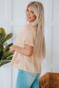 This cute top features a flowy fit, perfect for any occasion. With its split v neck and playful lace up detail, you'll be sure to turn heads. The ruffled trim on the short sleeves adds a touch of charm, while the print adds a unique flair. This versatile top is perfect for denim shorts, jeans, or tights. Cute Beige V-neck Top, Cute V-neck Blouse For Vacation, Cute V-neck Tops For Vacation, Cute V-neck Blouse For The Beach, Cute V-neck Blouse For Beach, Doll Blouse, Studio Flat, Babydoll Blouse, Babydoll Style