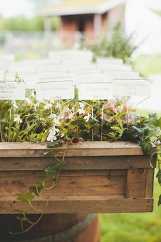 a wooden box filled with lots of flowers