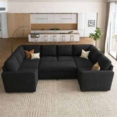 a large black couch sitting in a living room on top of a carpeted floor