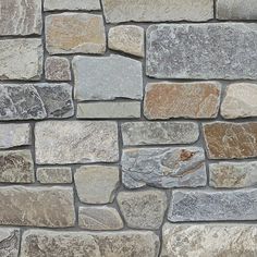 a stone wall made out of different colored rocks