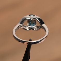 It is a London blue topaz ring. The main stone is 6 mm*8 mm oval cut.weight about 1.47 carats. The basic metal is sterling silver and plated with rhodium. To change the metal to a solid gold (white/rose) or platinum is also available, please ask for a quotation if you want. You can also go to my shop Home for more elegant rings: https://www.etsy.com/shop/godjewelry?ref=hdr_shop_menu London blue topaz is November birthstone More London blue topaz rings: https://www.etsy.com/shop/godjewelry/items? Blue Topaz Rings, Topaz Rings, Elegant Rings, Blue Gemstone Rings, Silver Engagement Ring, Spinel Ring, Engagement Ring For Women, London Blue Topaz Ring, Sterling Silver Engagement Rings