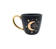 a black and gold coffee cup with the words moon gazing on it