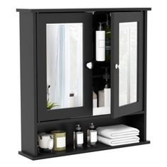 a bathroom cabinet with two mirrors and towels