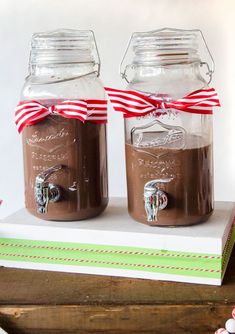 two mason jars filled with chocolate pudding on top of a book