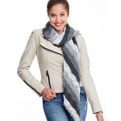 a woman is wearing a scarf and jacket