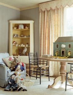 a living room filled with furniture and a doll house