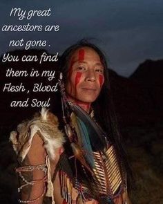 a native american man with his face painted in red and white, holding a cat