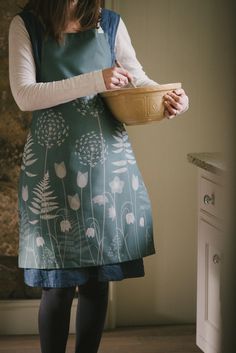 a woman holding a wooden bowl in her right hand and wearing tights on the other side