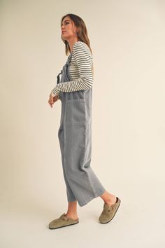 The vintage washed jumpsuit in dusty blue/gray boasts a loose fit and adjustable straps for maximum comfort. Complete with front pockets and faux back pockets, it offers a super cute casual look perfect for any occasion. Elevate your style with this must-have piece. -Fits true to size -70% Tencel/30% Rayon Utility Washed Overalls Jumpsuit, Casual Overalls With Pockets For Loungewear, Casual Washed Bib Front Overalls, Casual Washed Overalls With Bib Front, Utility Overalls In Washed Blue With Pockets, Utility Jumpsuits And Rompers With Adjustable Straps For Spring, Casual Relaxed Fit Overalls With Adjustable Straps, Casual Overalls With Adjustable Straps And Relaxed Fit, Blue Cotton Jumpsuits And Rompers With Adjustable Straps