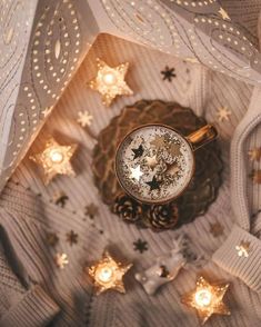 an overhead view of a clock surrounded by christmas lights and knitted sweaters with stars on them