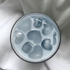 a glass filled with liquid on top of a white cloth