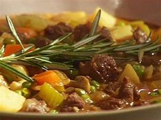 a bowl filled with meat and vegetables on top of a table