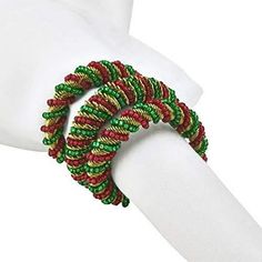 a white mannequin wearing a red and green bracelet on it's arm