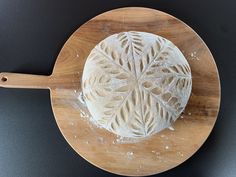 a piece of bread sitting on top of a wooden plate