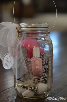 a mason jar filled with nail polish and other items