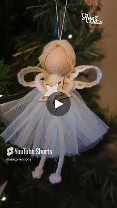 an angel ornament hanging from a christmas tree with the words you tube short below it