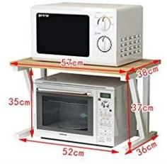 two microwaves are stacked on top of each other, with measurements for the size