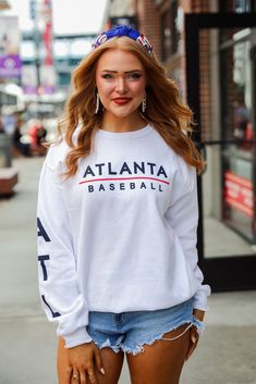 Calling all Braves fans, the White Atlanta Baseball Sweatshirt was made just for you! This comfy sweatshirt is designed with a soft and stretchy knit with a fleece interior. It features a crew neckline, long sleeves with "ATL" down them, a relaxed fit, and the words "Atlanta Baseball" on the front. Style the White Atlanta Baseball Sweatshirt with your favorite denim and a baseball hat for a cute game day look! Jerzees Brand Soft + Stretchy Knit Fabrication Fleece Interior "Atlanta Baseball" Grap White Long Sleeve Fan Apparel Sweatshirt, Sporty Long Sleeve Sweater With Letter Print, Game Day Graphic Print Long Sleeve Sweatshirt, Collegiate Sweater For Game Day, Collegiate Long Sleeve Sweater For Game Day, Long Sleeve Graphic Print Sweats For Sports Season, White Stretch Crew Neck Sweatshirt, Basic Long Sleeve Stretch Sweatshirt, Game Day Fan Apparel Long Sleeve Sweatshirt