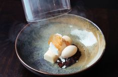 a bowl with some food in it on a table