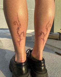 the legs of a person with tattoos on them