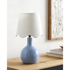 a blue lamp sitting on top of a wooden table