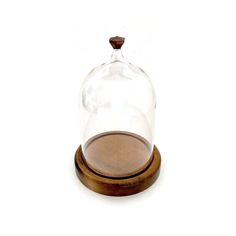 a glass clochet with wooden base on a white background, it is empty