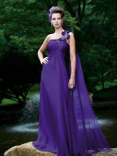 a woman in a purple dress posing for the camera