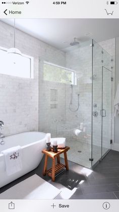 a white bath tub sitting next to a walk in shower