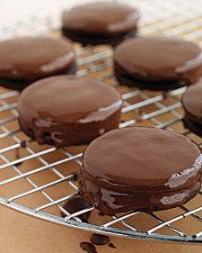 chocolate covered cookies sitting on top of a cooling rack