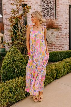 - Get a resort ready look with this vibrant maxi! - Colorful material with a paisley print - A built-in partial lining ending above the knee - A square cut neckline - 1.5 inch tie closure straps - A smocked upper back - Hidden side pockets - A flowy silhouette that ends in a rifle maxi length hemline Paisley Maxi Dress, Square Cut, Above The Knee, Paisley Print, The Knee, Paisley, Built In, Maxi Dress, Luxury Fashion