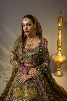 Mehendi Green Pakistani Bridal Dress in Royal Lehenga Choli Style embroidery of resham work with hand zardozi of Nakshi , Pearls , Swarovaski , Gotta , Dabka, sequence pearls. Detailed Description: SKU: BB334 Detailing: Embroidery, Zardosi, Sequins, Naqshi, Dabka, Mukaish, Cut-dana Color: Mehendi Green Fabric: Chiffon,Tissue Design: Fully Embellished Dress with Sequins, Dabka, Goldwork Event: Bridal wear, Wedding Green Pakistani Bridal Dress, Royal Lehenga, Choli Style, Designer Mehendi, Pakistani Bridal Lehenga, Pakistani Bridal Dress, Resham Work, Lehenga Choli Online, Pakistani Bridal Dresses