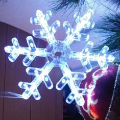 a lighted snowflake hanging from the ceiling