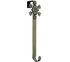 a snowflake is mounted to the side of a pole with a hook on it