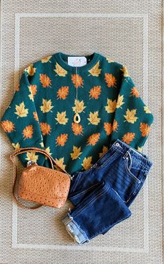 Knit green sweater with orange and yellow leaves. Graphic Print Knit Sweater For Fall, Retro Graphic Print Sweater For Fall, Fall Crew Neck Sweater With Graphic Print, Fall Graphic Print Knit Sweater, Fall Cotton Sweater With Cat Print, Yellow Leaves, Green Sweater, Top Graphic Tees, Loungewear Sets