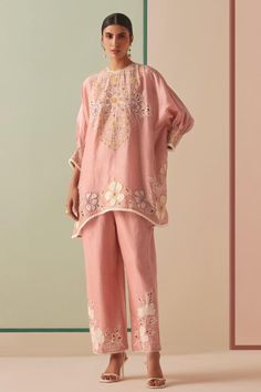 Old rose chanderi kurta with cutwork and cordwork applique embroidery. Comes with pant.
Components: 2
Pattern: Applique embroidered
Type Of Work: Cutwork, Cordwork
Neckline: Round
Sleeve Type: Flared Sleeves
Fabric: Chanderi, Lining : 100% Cotton
Color: Pink
Other Details: 
Attached lining
Model Height : 5 ft 6 inches, wearing size S
Occasion: Sangeet - Aza Fashions Indian Bride Outfits, Pakistani Fashion Casual, Kurti Collection, Dream Wedding Ideas Dresses, Boutique Dress Designs, Pakistani Dress Design, Kinds Of Clothes, Embroidery Suits, Embellished Top