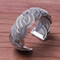 Two bands of sterling silver intertwine in a serpentine pattern to form this elegant cuff bracelet presented by Achara of Thailand. Each band is made of ten ribbons of sterling silver alternating in texture between smooth and a herringbone motif. The intertwined bands are capped on each end with a smooth bar. Silver Spiral Bohemian Bracelets, Elegant Silver Spiral Cuff Bracelet, Silver Bohemian Braided Bangle Bracelet, Bohemian Silver Braided Bangle Bracelet, Silver Chain Style, Sterling Silver Cuff Bracelet, Wire Bracelet, Sterling Silver Cuff, Gorgeous Bracelet