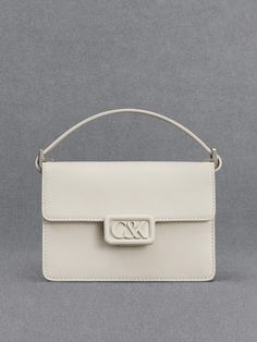 A polished and pristine all-white leather bag is an investment-worthy piece that deserves a spot in your capsule wardrobe - our boxy bag is a case in point. Made with genuine calf leather, this bag feels as luxurious as it looks. It opens up to a roomy main compartment that can hold your essentials and then some. The matching white hardware is polished and striking. Fitted with a thick shoulder strap that is also made with soft and supple leather, it will hang comfortably on your shoulder. Chic Rectangular Box Bag With Branded Hardware, Designer White Box Bag With Detachable Handle, Modern Box Bag With Branded Hardware For Office, Luxury White Box Bag With Detachable Handle, Luxury White Box Bag With Top Handle, Modern Office Box Bag With Branded Hardware, Designer White Rectangular Case Bag, Luxury White Box Bag For Evening, Luxury White Rectangular Case Bag