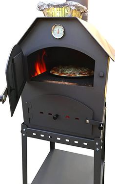 an outdoor pizza oven with the door open and a clock on it's side