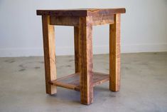 a small wooden table sitting on top of a cement floor